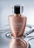 Snoir Blush Cèreme perfume bottle on a reflective surface with a gray background