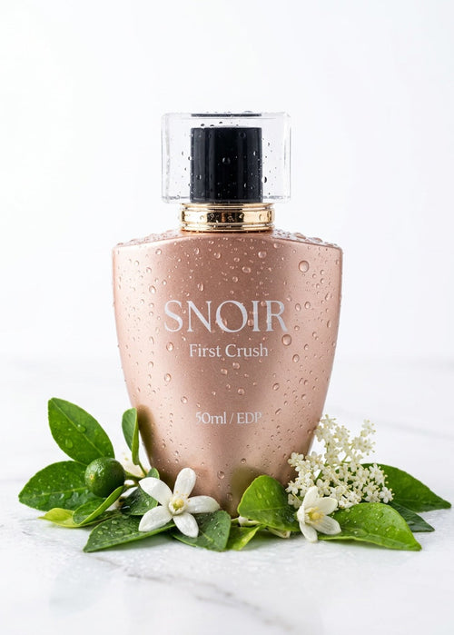 Perfume bottle labeled 'Snoir First Crush' with floral elements on a white background
