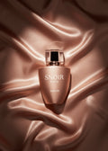 Snoir skincare bottle on a textured brown fabric background