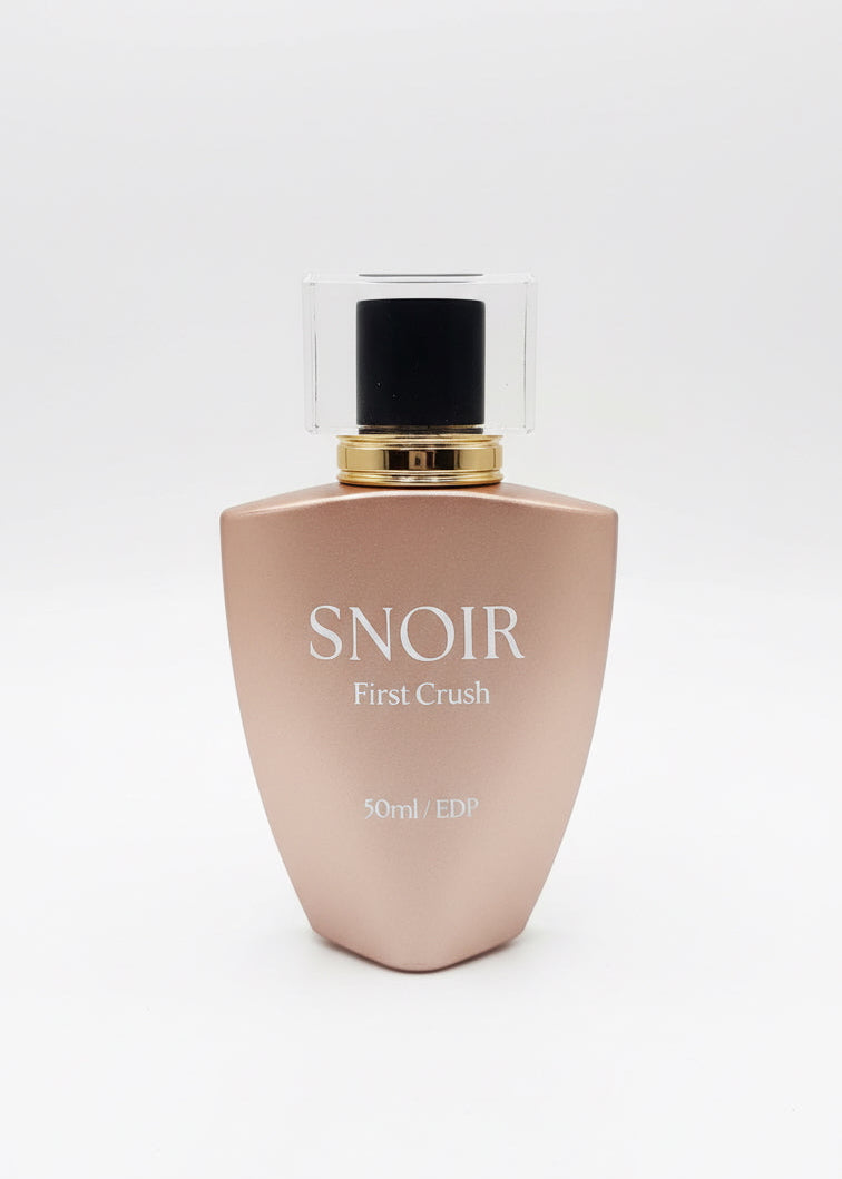 Perfume bottle labeled 'Snoir First Crush' on a white background